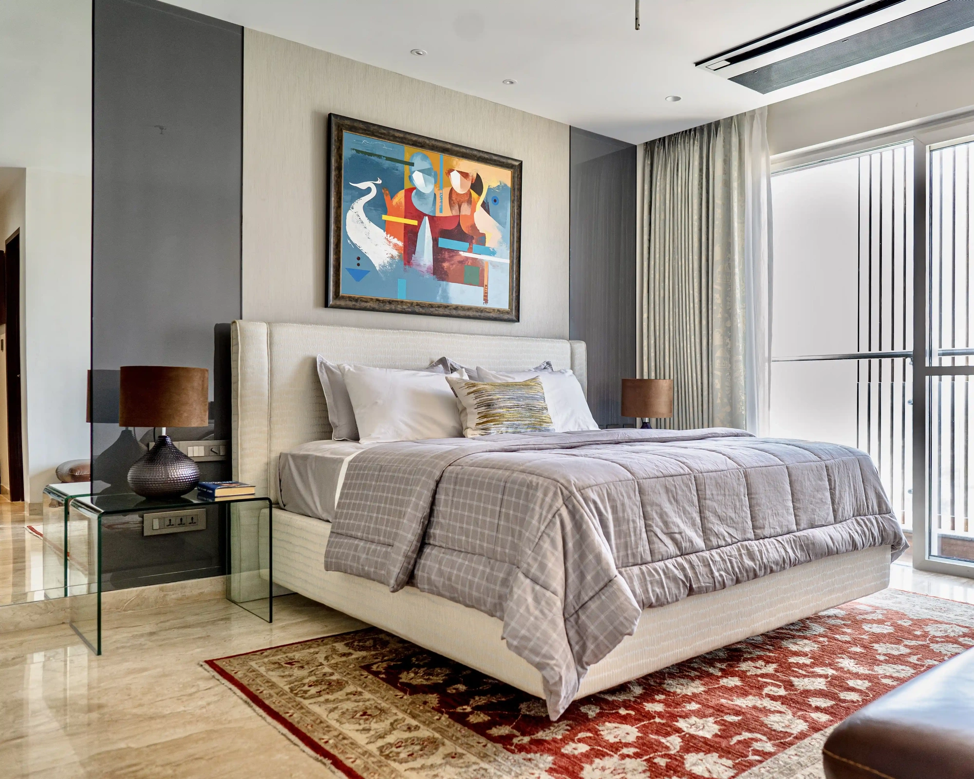 Kaizen Atelier bedroom interior with upholstered bed and natural light.